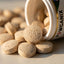 Pet supplement tablets spilling out of a container labeled 'Wganix' on a light surface.